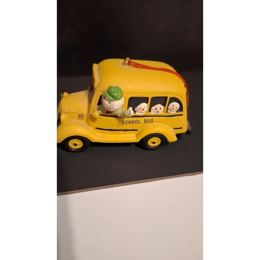 Resin school bus Christmas ornament with Santa and children
